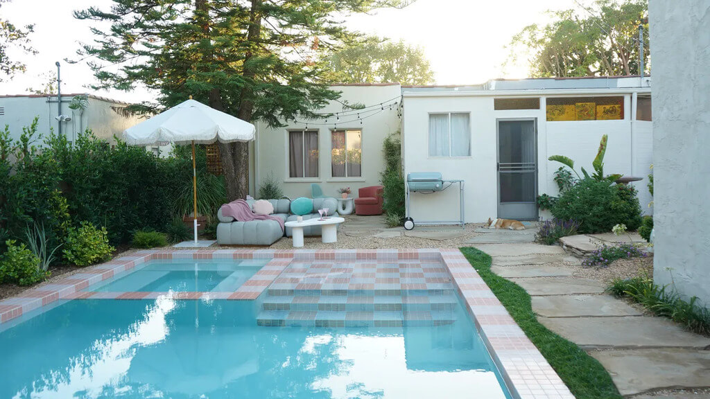 A backyard with a pool and patio furniture