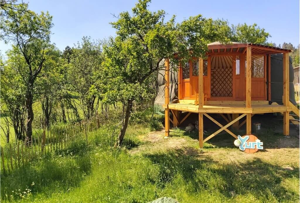 A small wooden structure in the middle of a field
