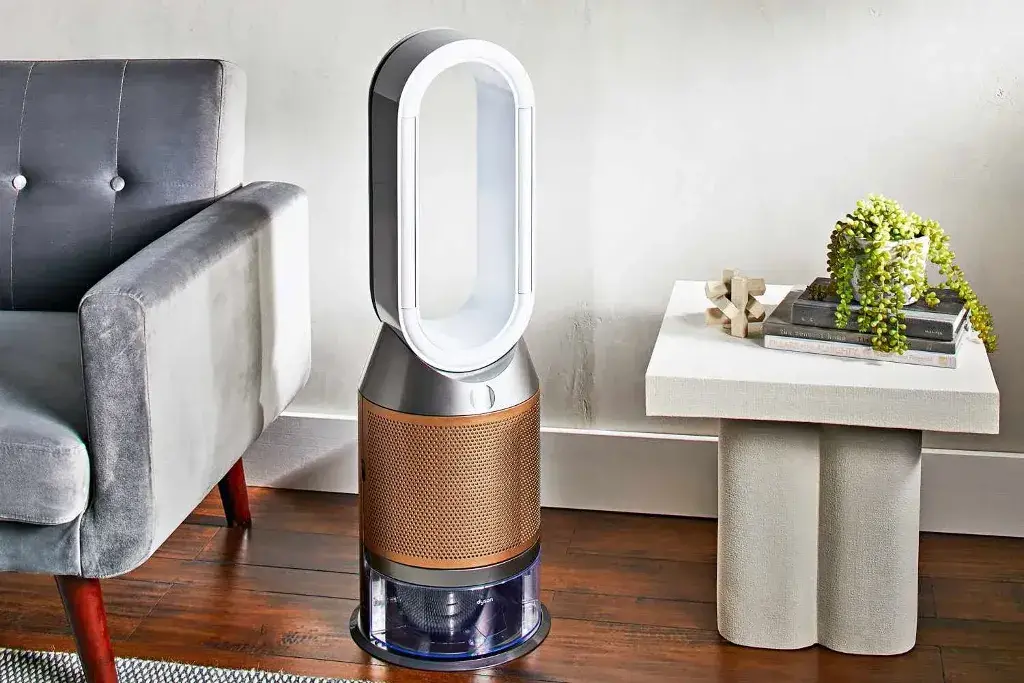 An air purifier on top of a wooden floor 
