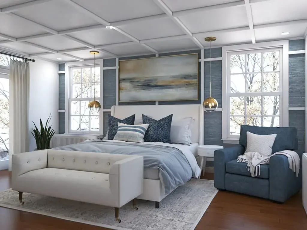 A bedroom with a bed, chair, and couch in it
