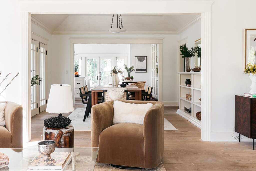 A living room with furniture and a dining room table
