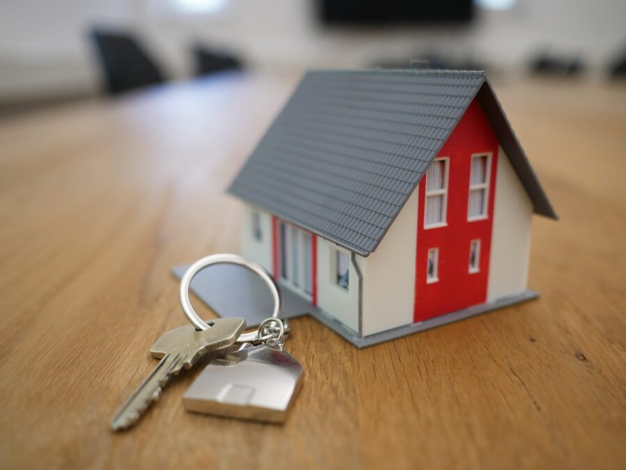 A house with a keychain and a house key on a table CopyDownload