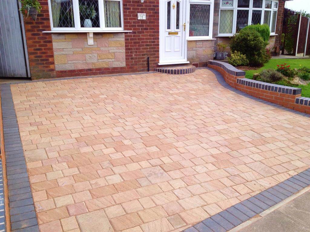 A brick driveway with a brick border
