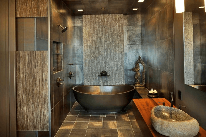 dark bathroom with walls and floor covered in brownish grey